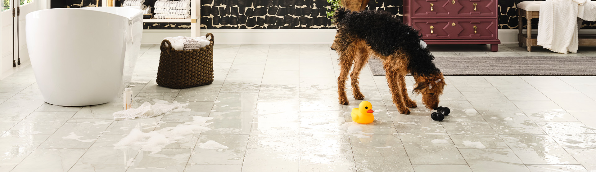 Florence 8025 Platinum Carrara hard surface flooring in a bathroom with a dog and water on the floor